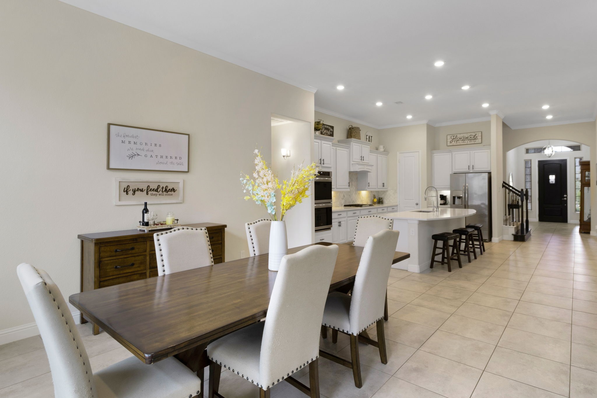 19248 Yellow Chestnut Lane New Caney, TX 77357 - Photo 6 of 42 a dining area with stainless steel appliances kitchen island granite countertop a dining table chairs and a refrigerator