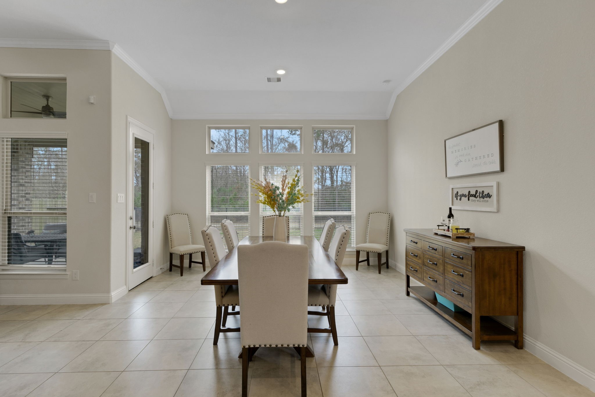19248 Yellow Chestnut Lane New Caney, TX 77357 - Photo 8 of 42 a dining room with furniture and large windows