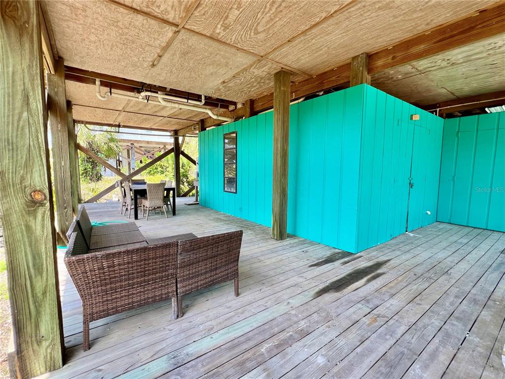 9580 Almirate Court Placida, FL 33946 - Photo 11 of 59 a house view with a wooden floor outdoor seating and deck