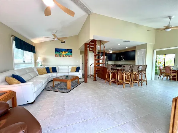 a living room with lots of furniture and a chandelier