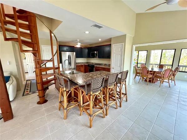 a kitchen with stainless steel appliances granite countertop a stove refrigerator and a sink