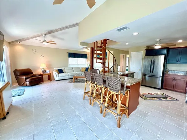 a kitchen with stainless steel appliances kitchen island granite countertop a stove and a sink
