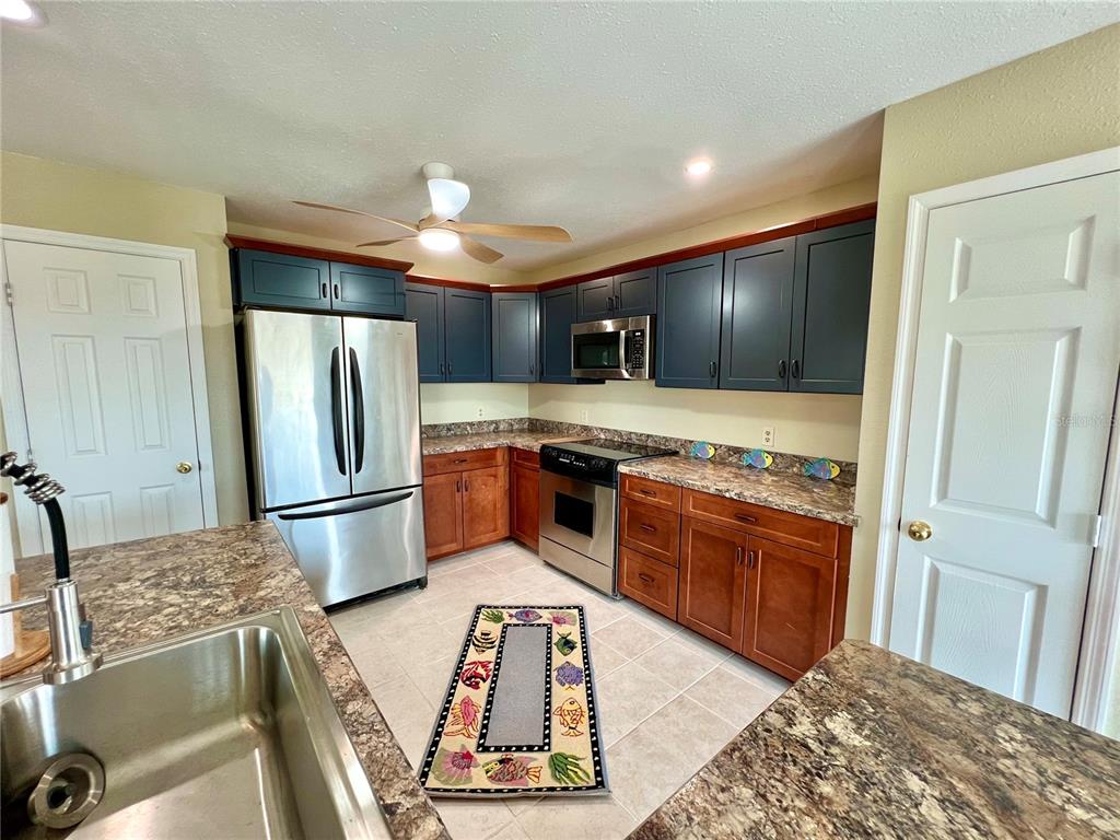 9580 Almirate Court Placida, FL 33946 - Photo 19 of 59 a kitchen with stainless steel appliances granite countertop a refrigerator and a stove top oven