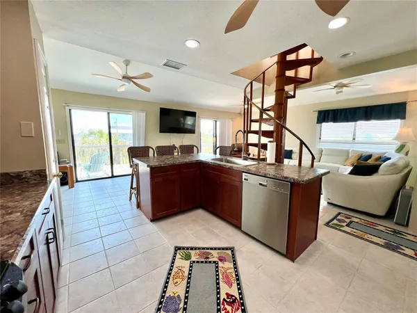 a dining room with furniture and a flat screen tv