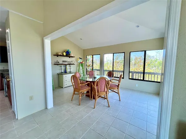 a dining room with furniture and a potted plant