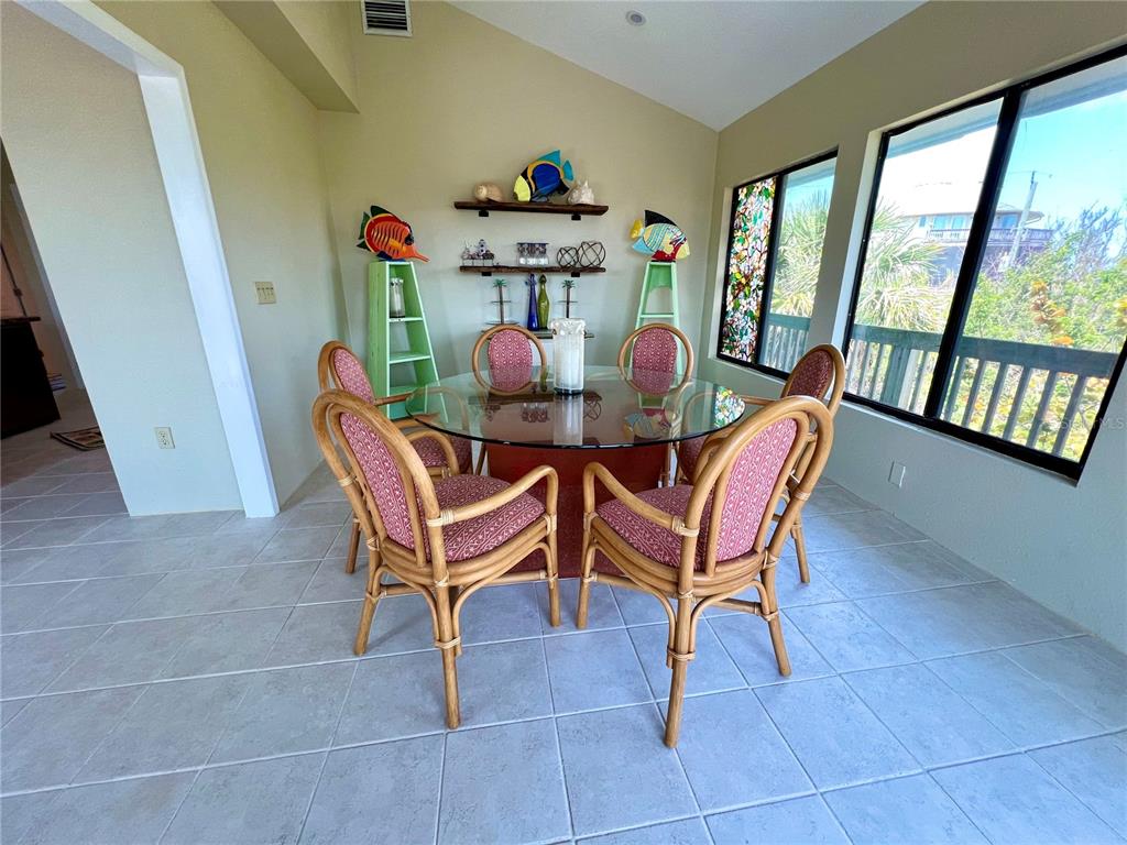 9580 Almirate Court Placida, FL 33946 - Photo 23 of 59 a dining room with furniture and large windows