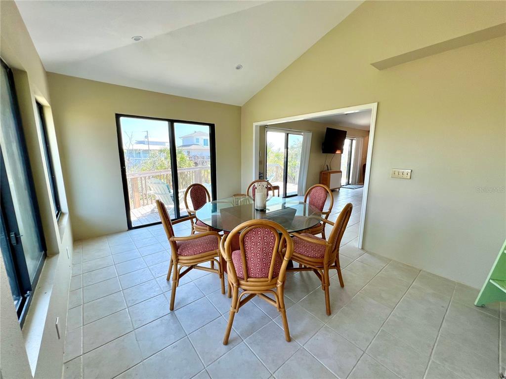9580 Almirate Court Placida, FL 33946 - Photo 25 of 59 a dining room with furniture and a potted plant