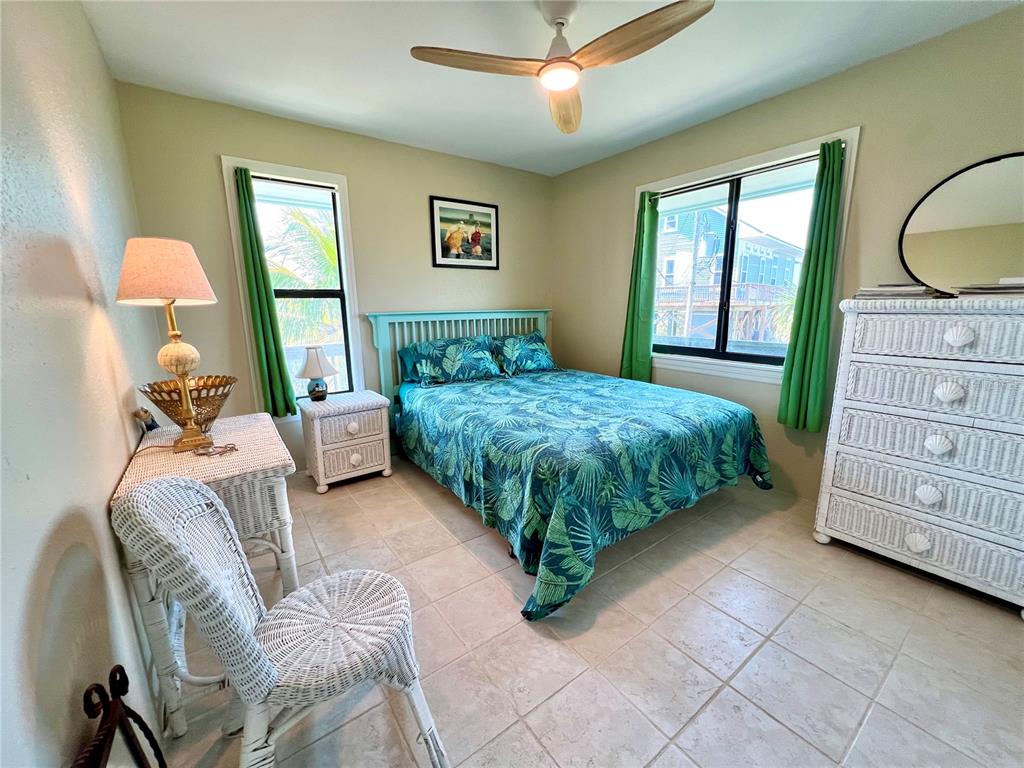 9580 Almirate Court Placida, FL 33946 - Photo 28 of 59 a bedroom with a bed a dresser and next to a window