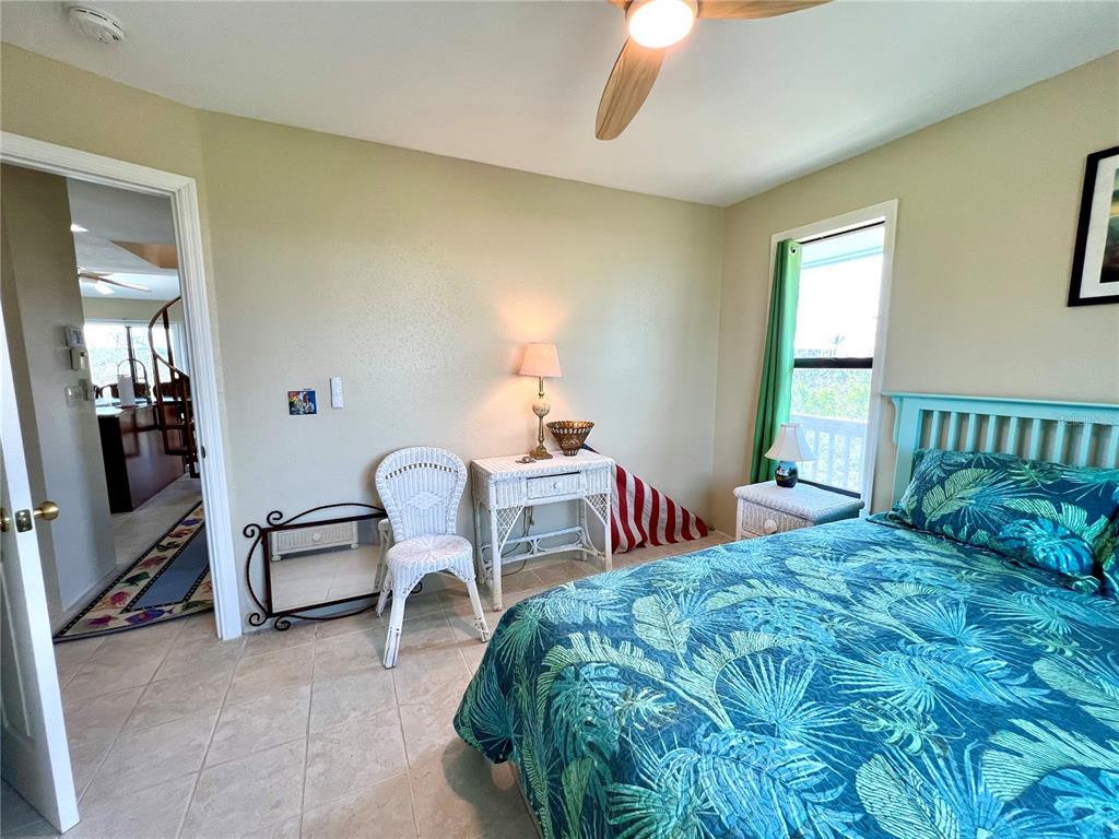 9580 Almirate Court Placida, FL 33946 - Photo 30 of 59 a bedroom with a bed chair and windows