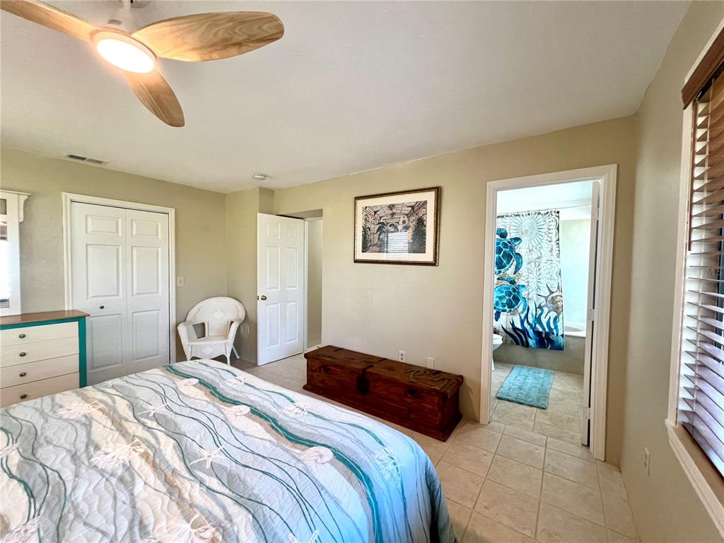 9580 Almirate Court Placida, FL 33946 - Photo 34 of 59 a bedroom with a bed and a chandelier