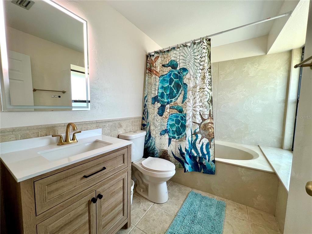 9580 Almirate Court Placida, FL 33946 - Photo 35 of 59 a bathroom with a sink a toilet and a bathtub