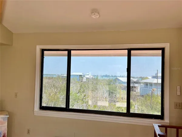 a view of a lake with couches chairs