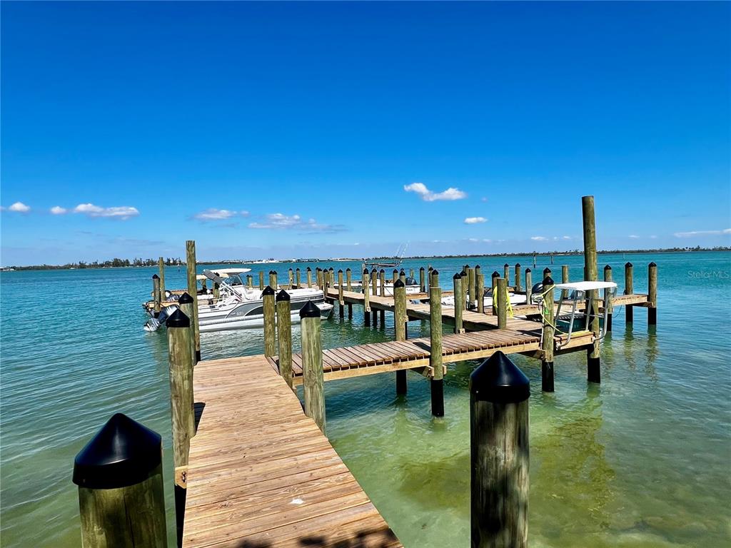 9580 Almirate Court Placida, FL 33946 - Photo 44 of 59 a group of people sitting on a pier in a patio