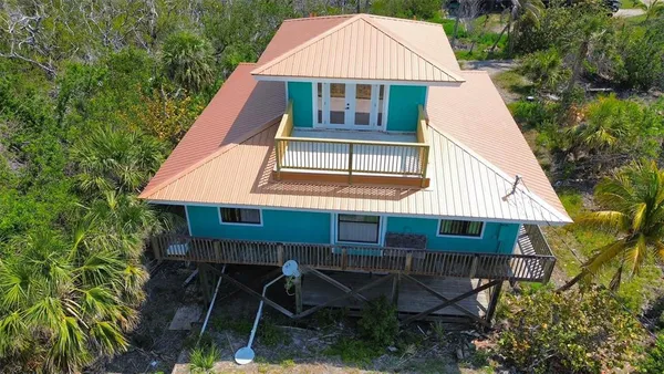 a aerial view of a house with yard and sitting area