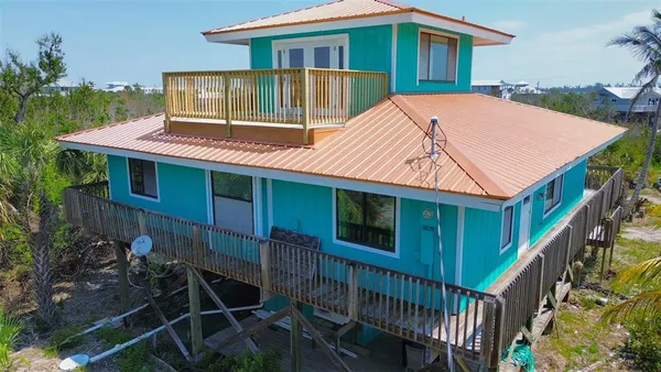 a view of a house with backyard and deck