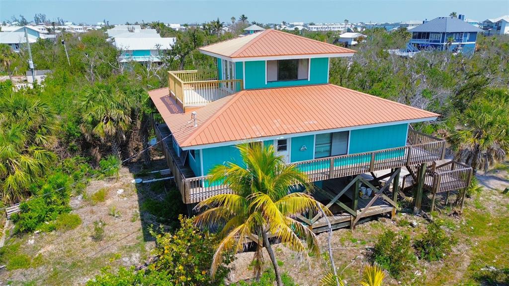 9580 Almirate Court Placida, FL 33946 - Photo 10 of 59 an aerial view of a house with table and chairs under an umbrella