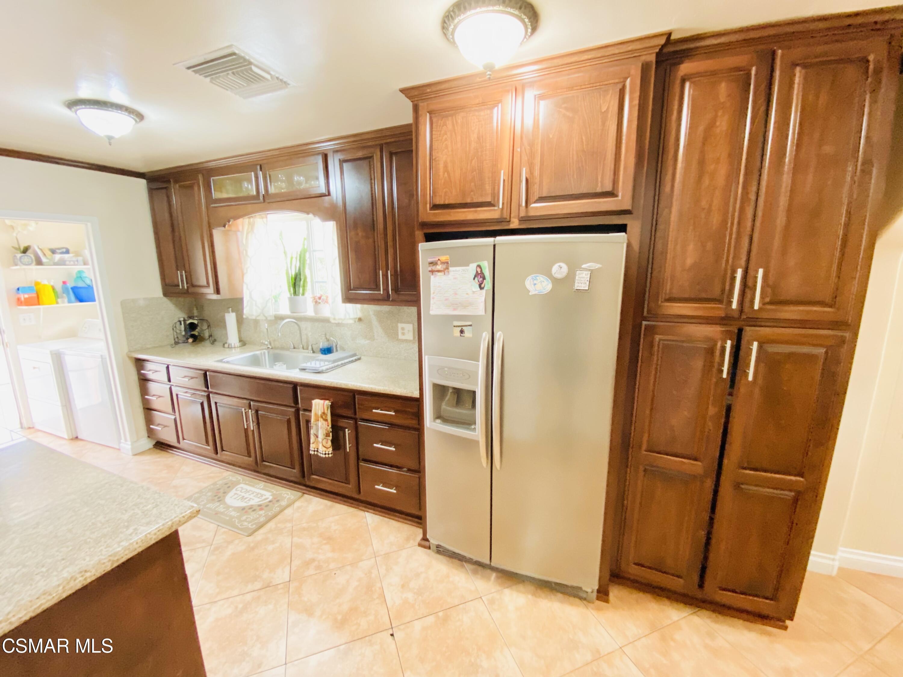 13628 Wingo Street Arleta, CA 91331 - Photo 14 of 55 a kitchen with stainless steel appliances a refrigerator a sink a stove a counter top space and cabinets