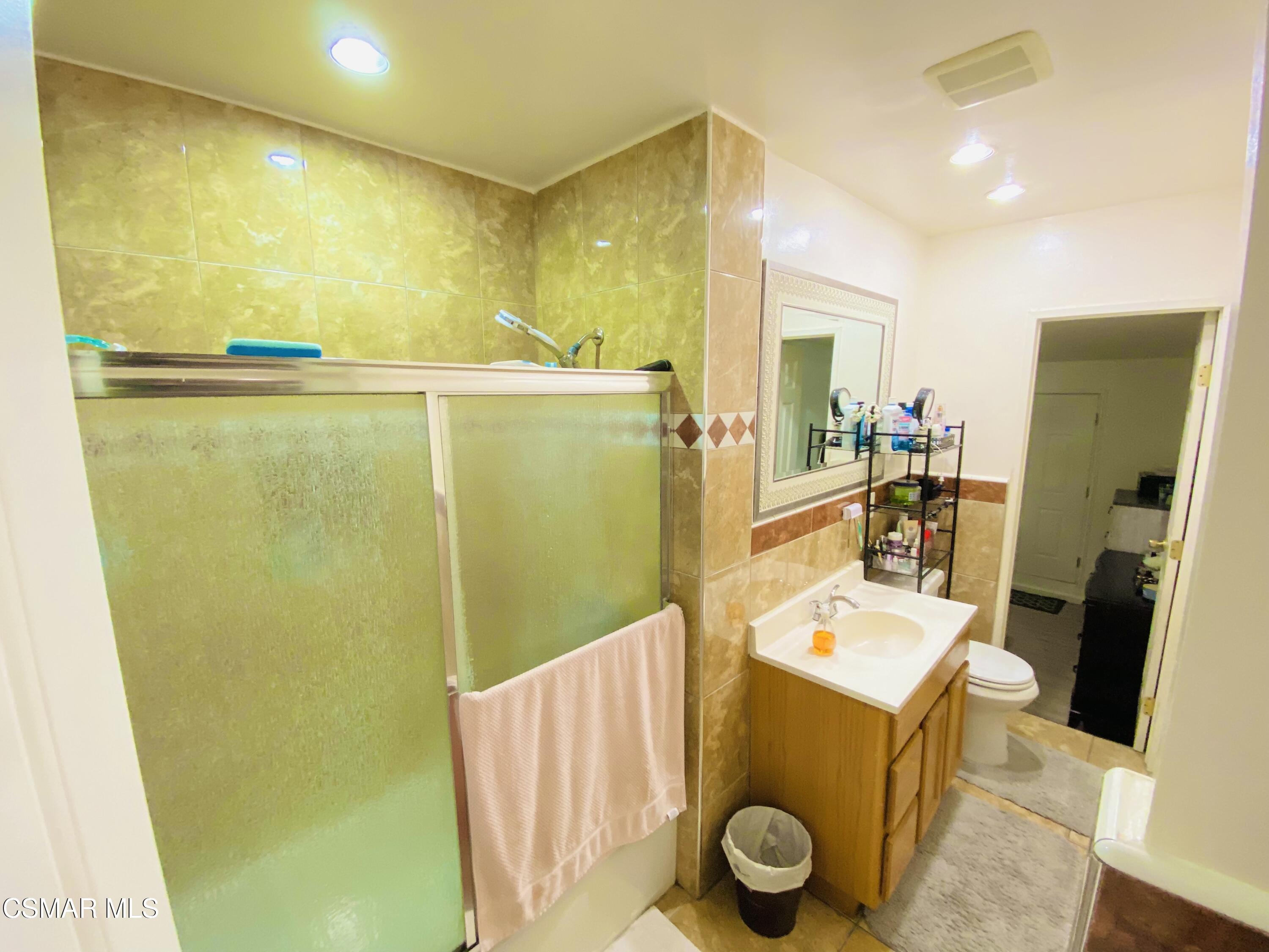 13628 Wingo Street Arleta, CA 91331 - Photo 17 of 55 a bathroom with a mirror