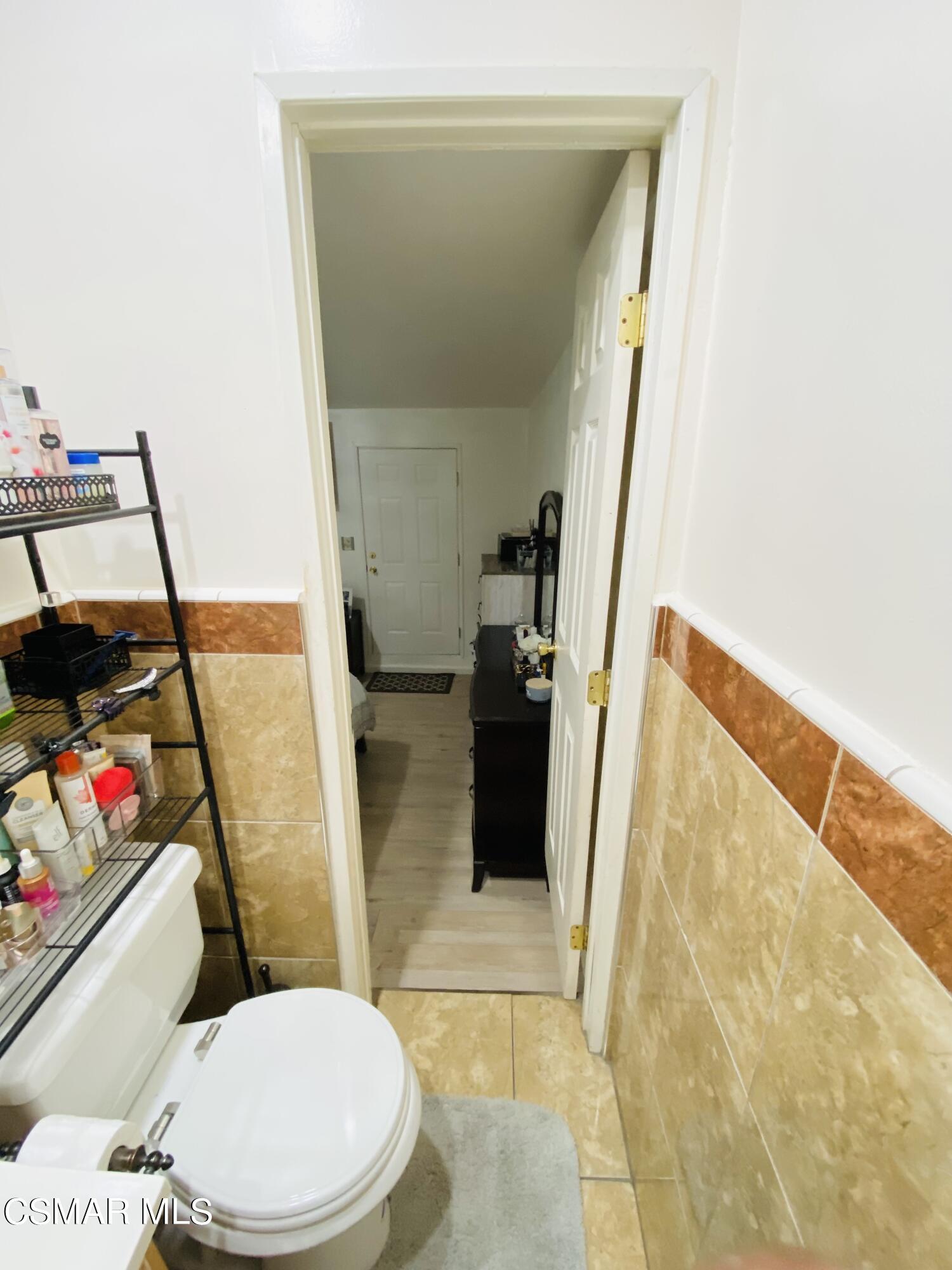 13628 Wingo Street Arleta, CA 91331 - Photo 21 of 55 a white toilet sitting next to a bathroom sink and a tub