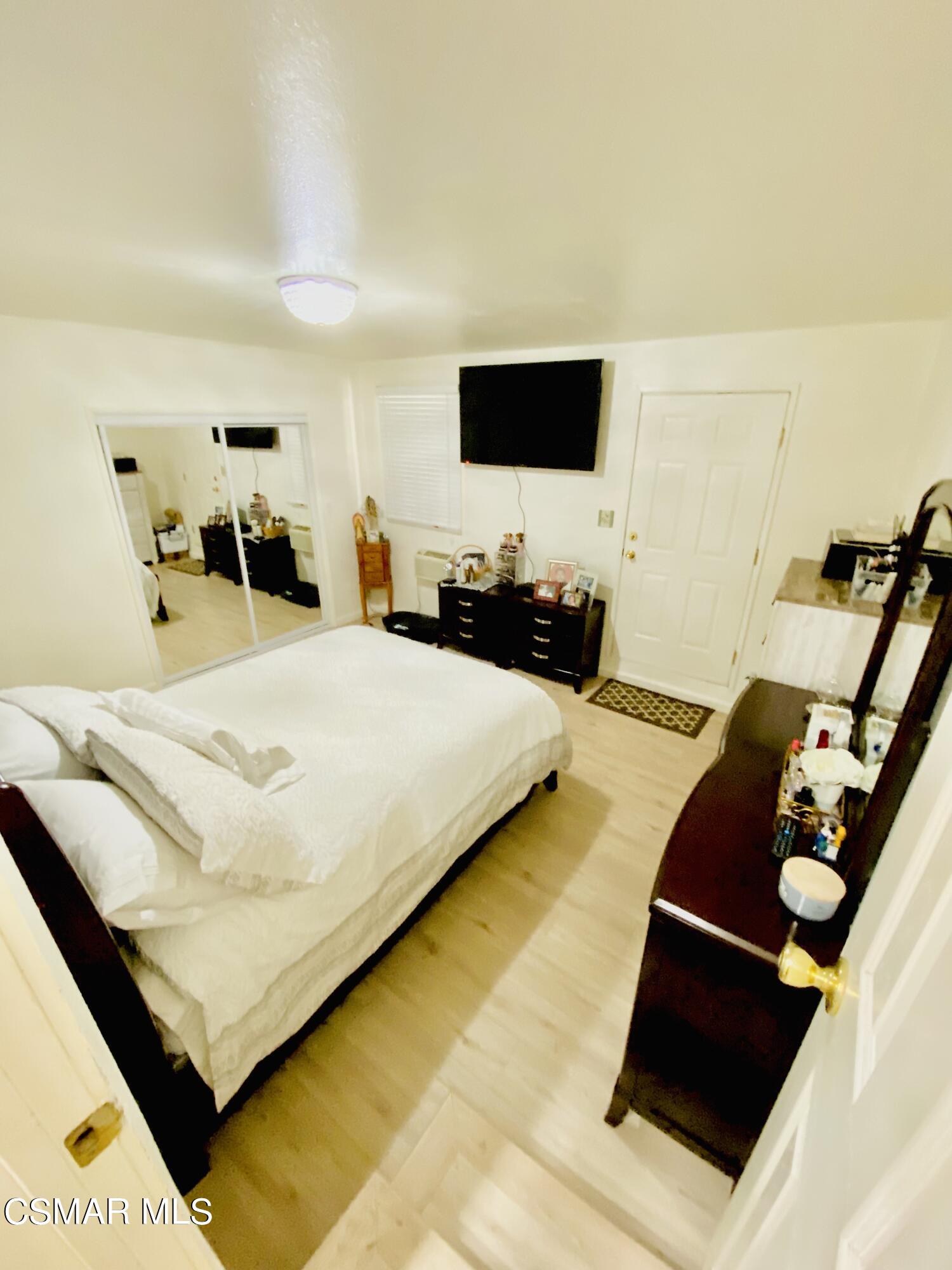 13628 Wingo Street Arleta, CA 91331 - Photo 22 of 55 a bedroom with a bed and flat screen tv