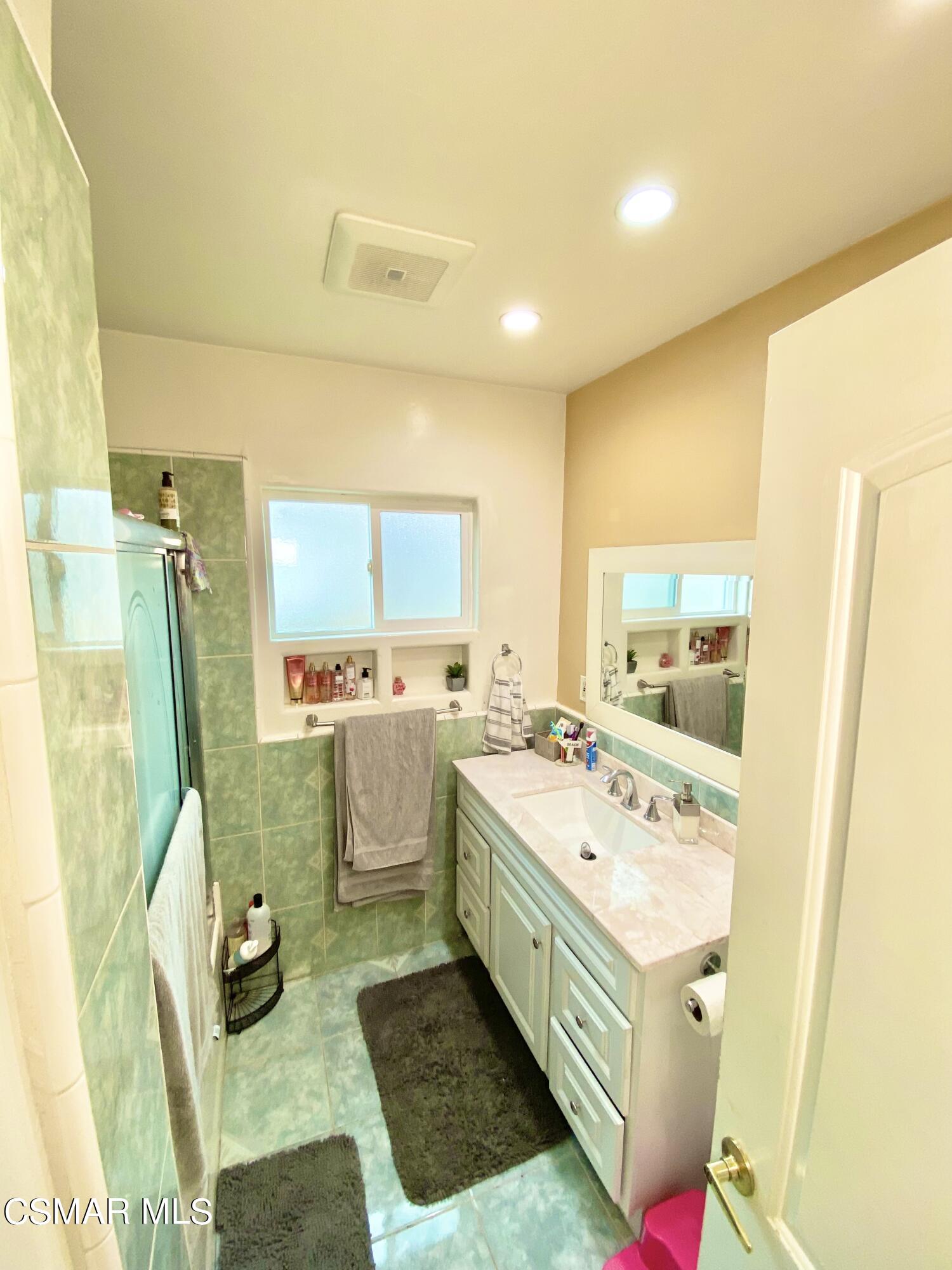 13628 Wingo Street Arleta, CA 91331 - Photo 34 of 55 a bathroom with a sink a toilet and mirror