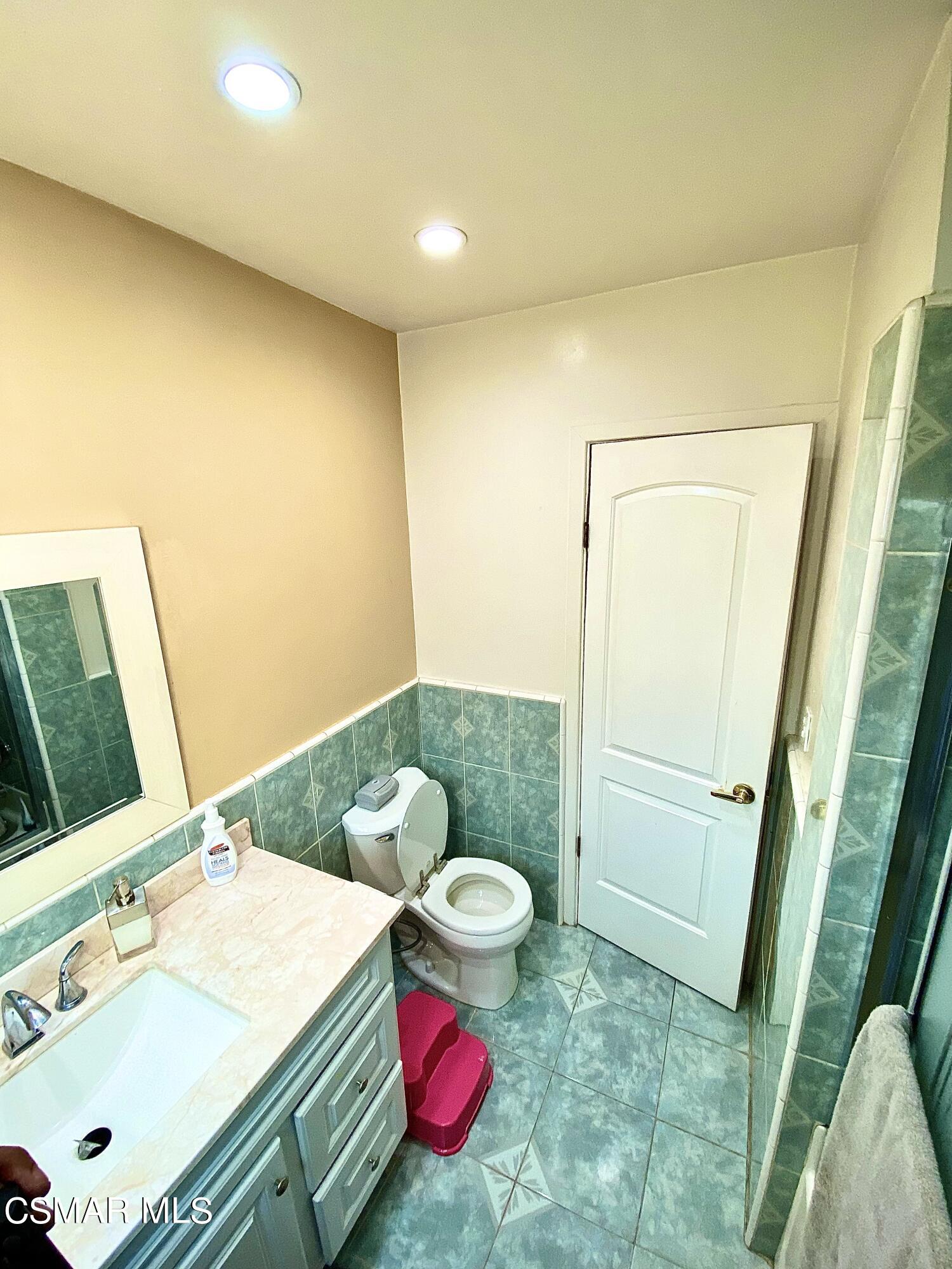 13628 Wingo Street Arleta, CA 91331 - Photo 35 of 55 a bathroom with a sink and a mirror