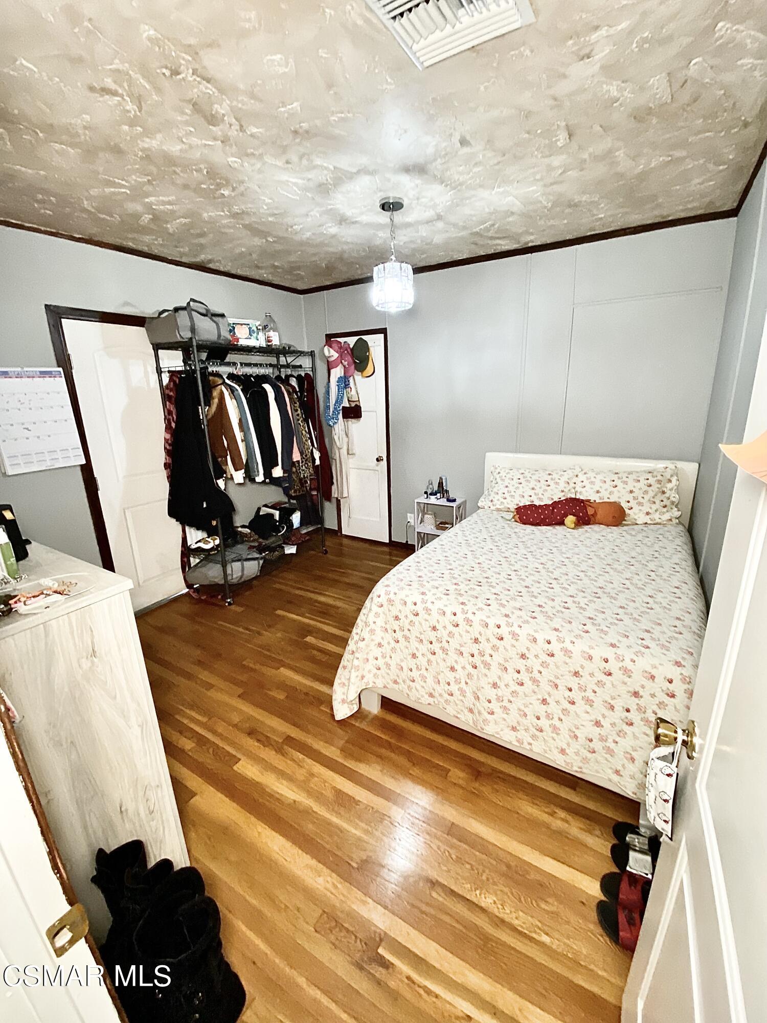 13628 Wingo Street Arleta, CA 91331 - Photo 38 of 55 a bedroom with a bed and a walk in closet