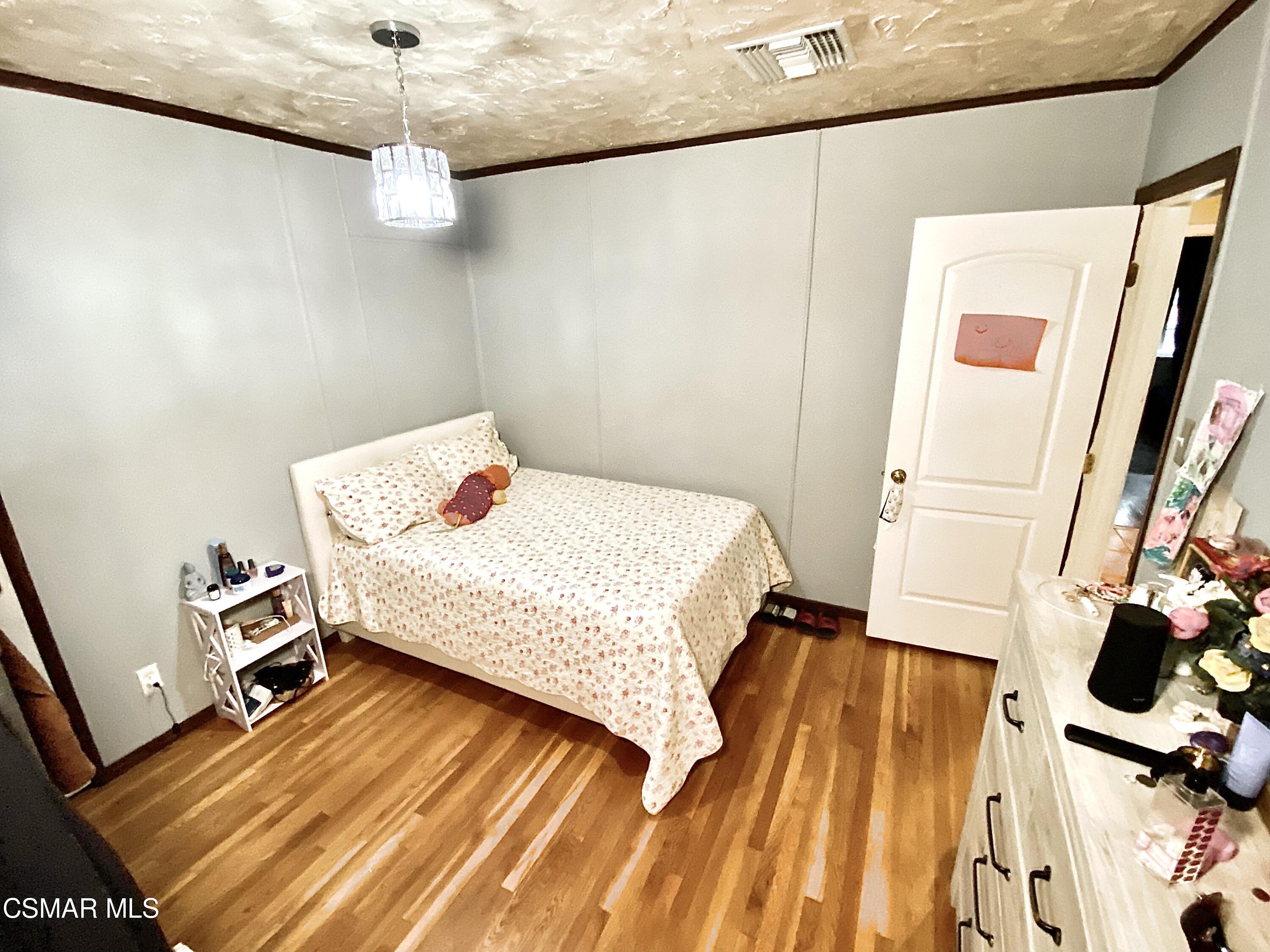 13628 Wingo Street Arleta, CA 91331 - Photo 40 of 55 a bedroom with a bed and a mirror on the dresser