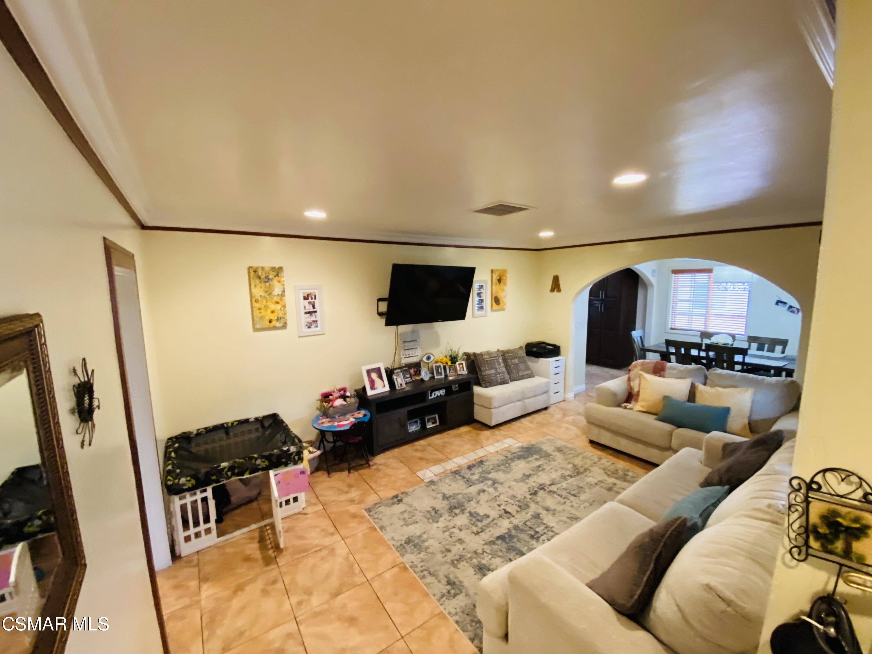 13628 Wingo Street Arleta, CA 91331 - Photo 5 of 55 a living room with furniture and a flat screen tv