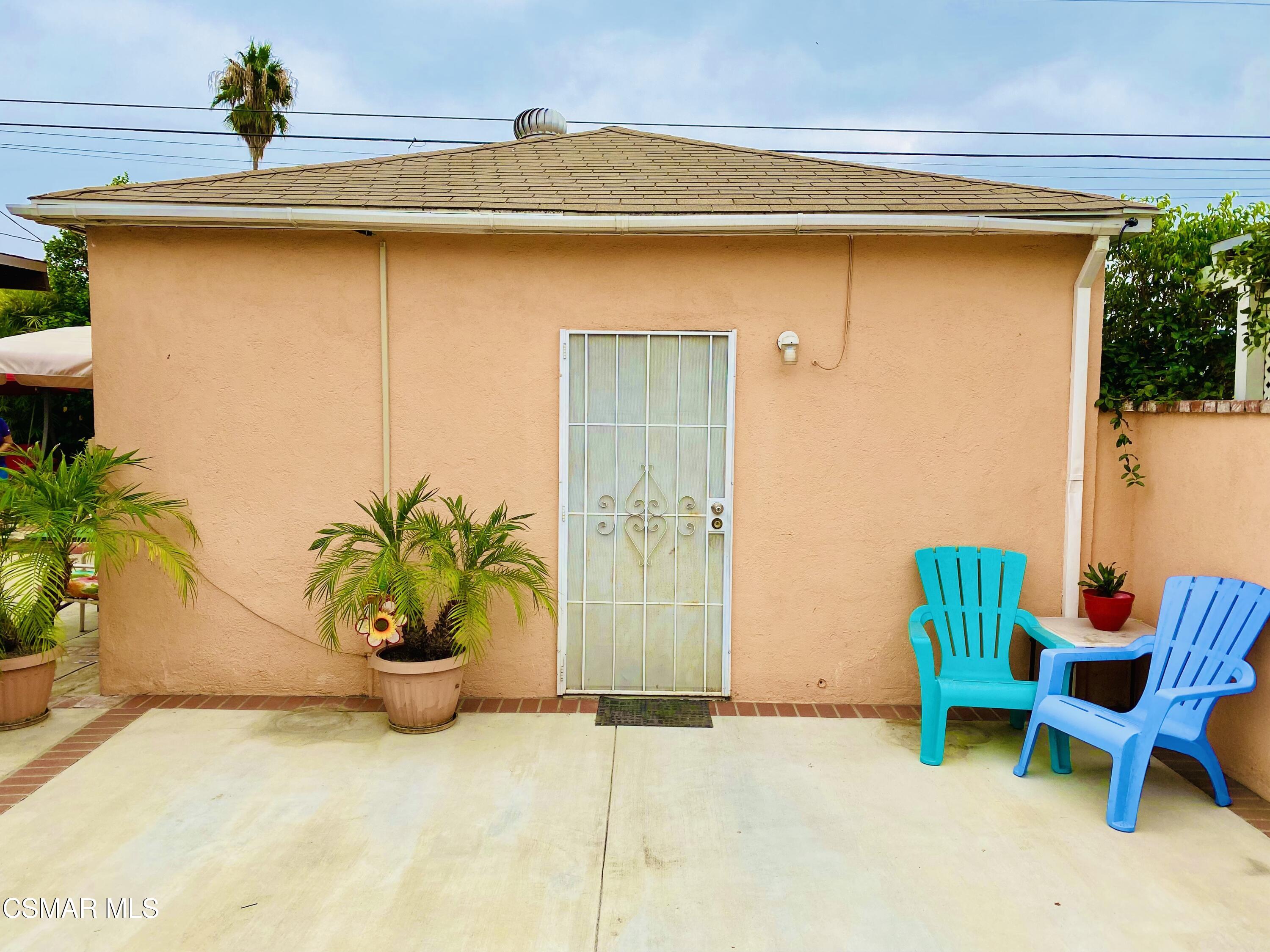 13628 Wingo Street Arleta, CA 91331 - Photo 41 of 55 a potted plant sitting in front of a glass door