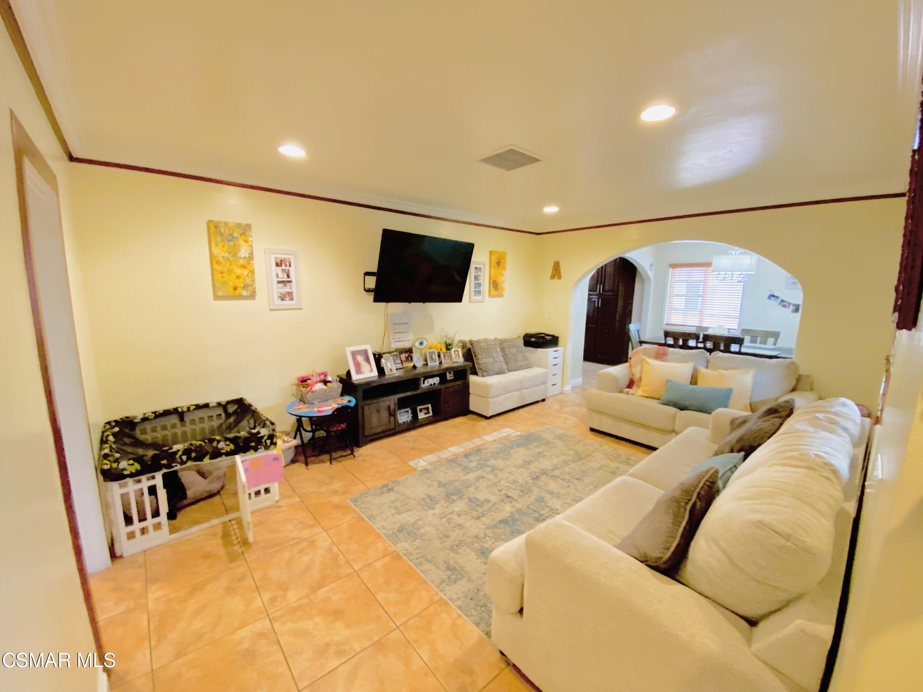 13628 Wingo Street Arleta, CA 91331 - Photo 6 of 55 a living room with furniture and a flat screen tv