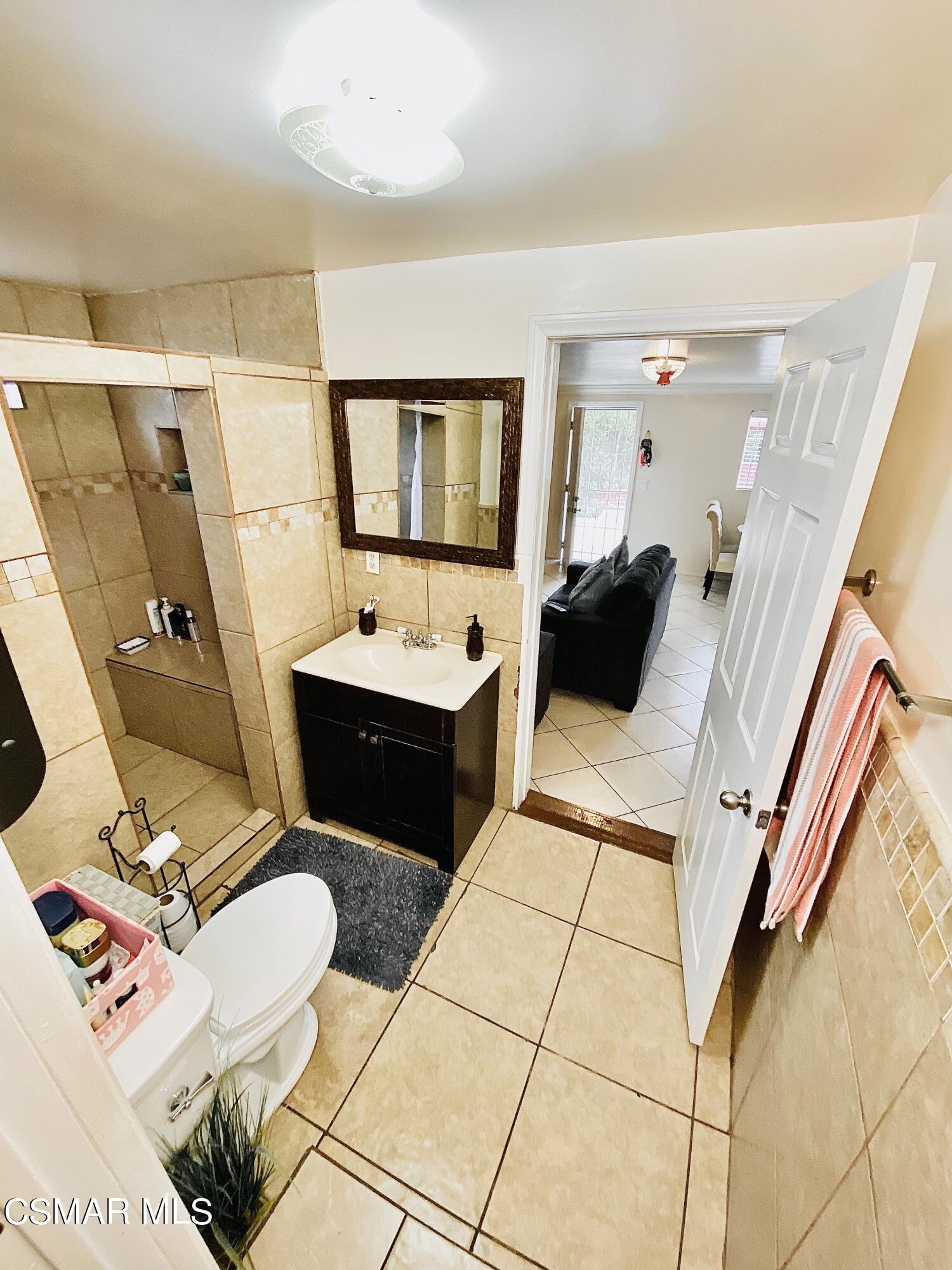 13628 Wingo Street Arleta, CA 91331 - Photo 54 of 55 a bathroom with a sink toilet and mirror