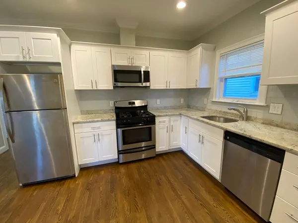 a kitchen with stainless steel appliances a refrigerator sink and microwave
