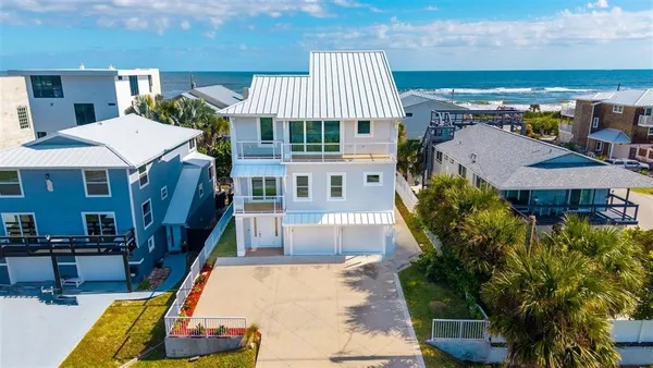 a aerial view of a house with swimming pool and furniture