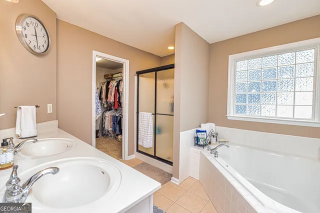a bathroom with a tub sink and a window