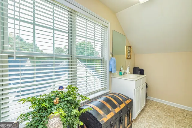 a bedroom with a bed and a potted plant