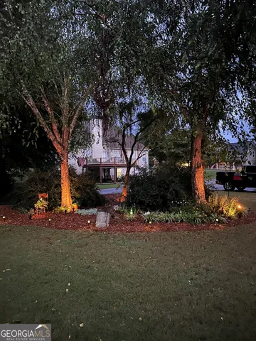a backyard of a house with table and chairs