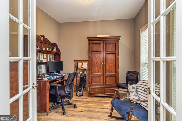 a view of a workspace with furniture and a window