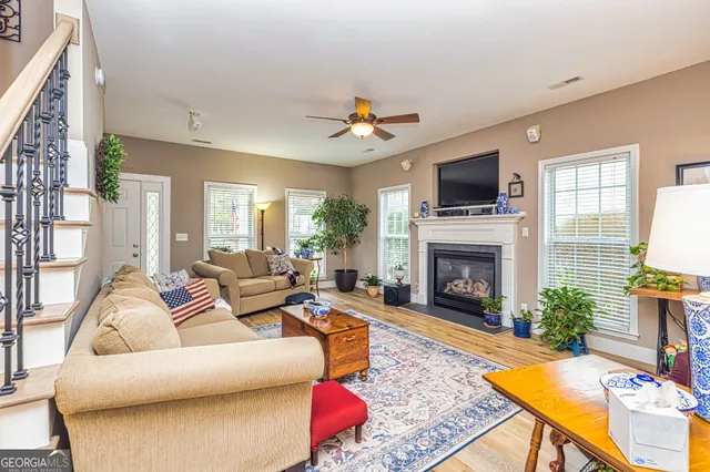 a living room with furniture a fireplace and a flat screen tv