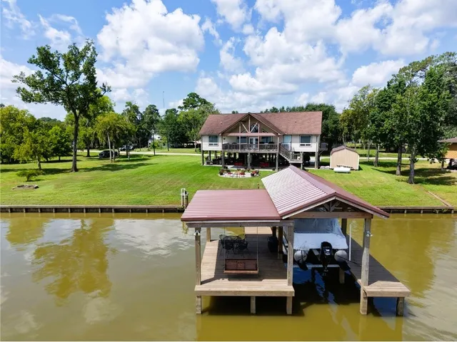 a aerial view of a house with swimming pool and green space