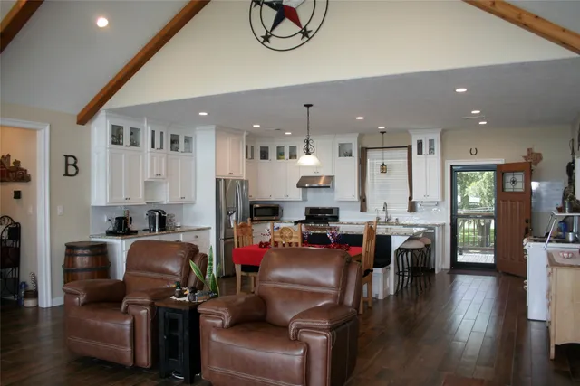 a view of living room kitchen with furniture and wooden floor