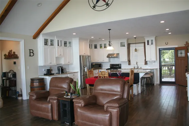 a living room with furniture and kitchen view
