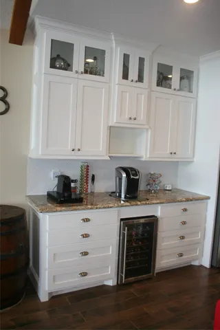 a kitchen with granite countertop white cabinets and white appliances