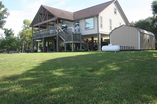 a view of a house with a yard and sitting area