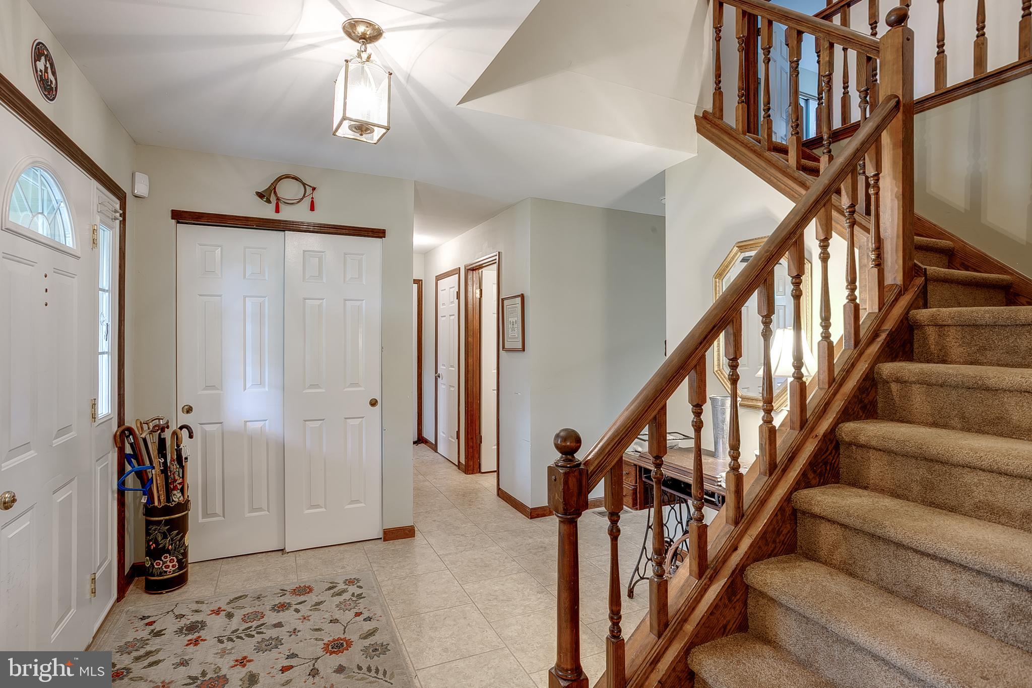 402 Doerrmann Drive Mickleton, NJ 08056 - Photo 3 of 34 a view of staircase with lots of frames on wall and wooden floor