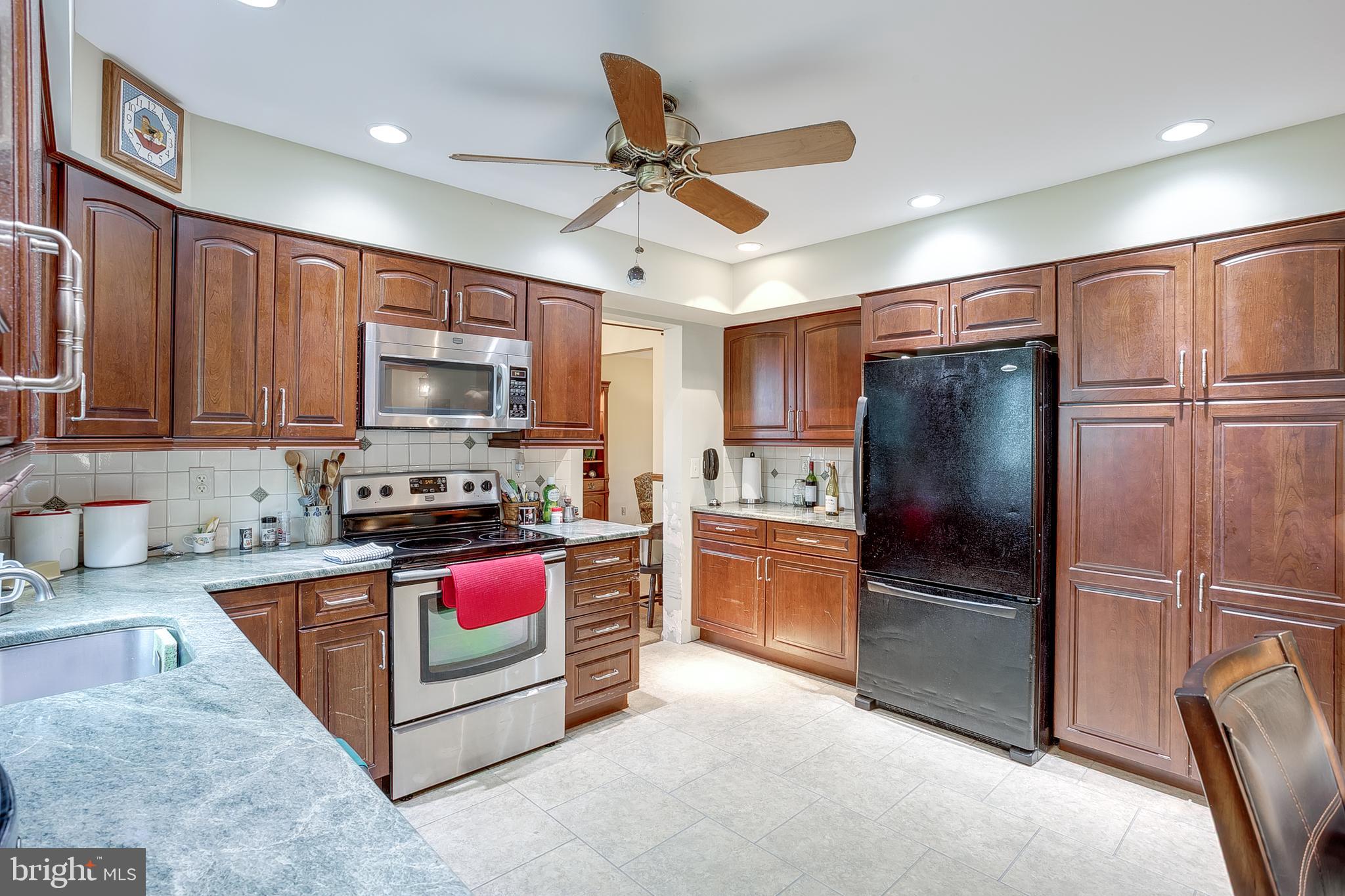 402 Doerrmann Drive Mickleton, NJ 08056 - Photo 10 of 34 a kitchen with stainless steel appliances granite countertop a refrigerator stove top oven a sink and dishwasher