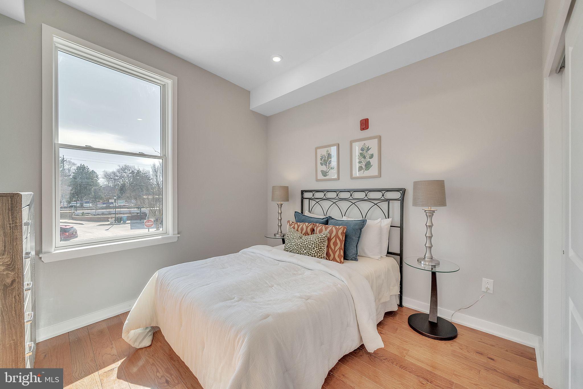 100 Forrest Avenue, Unit 204 Narberth, PA 19072 - Photo 12 of 17 a bedroom with a bed and a window