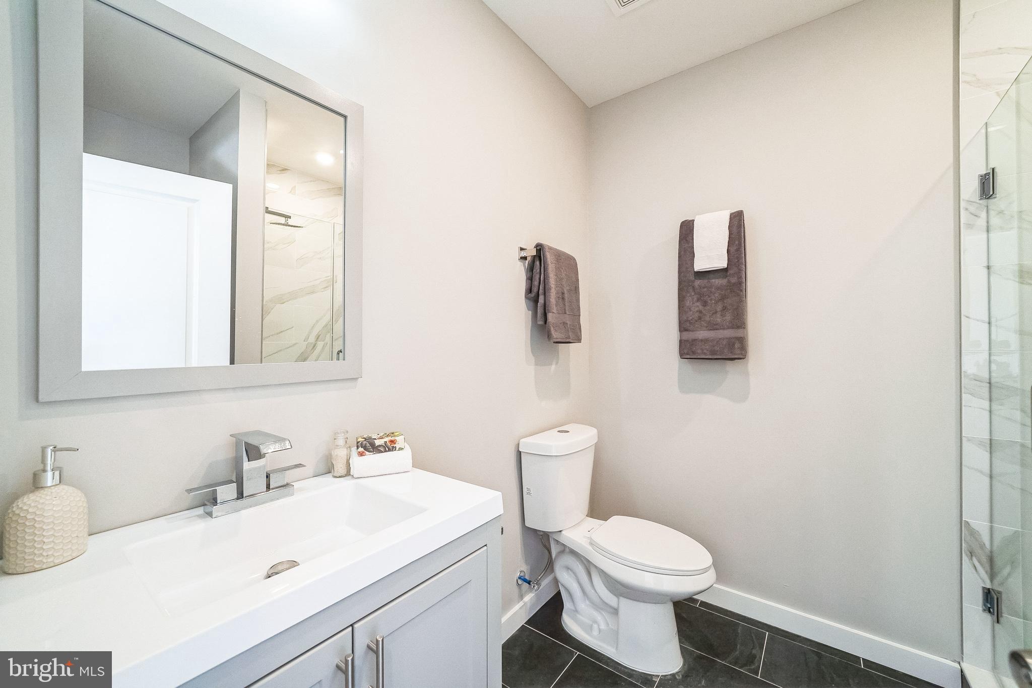 100 Forrest Avenue, Unit 204 Narberth, PA 19072 - Photo 13 of 17 a bathroom with a sink toilet and mirror