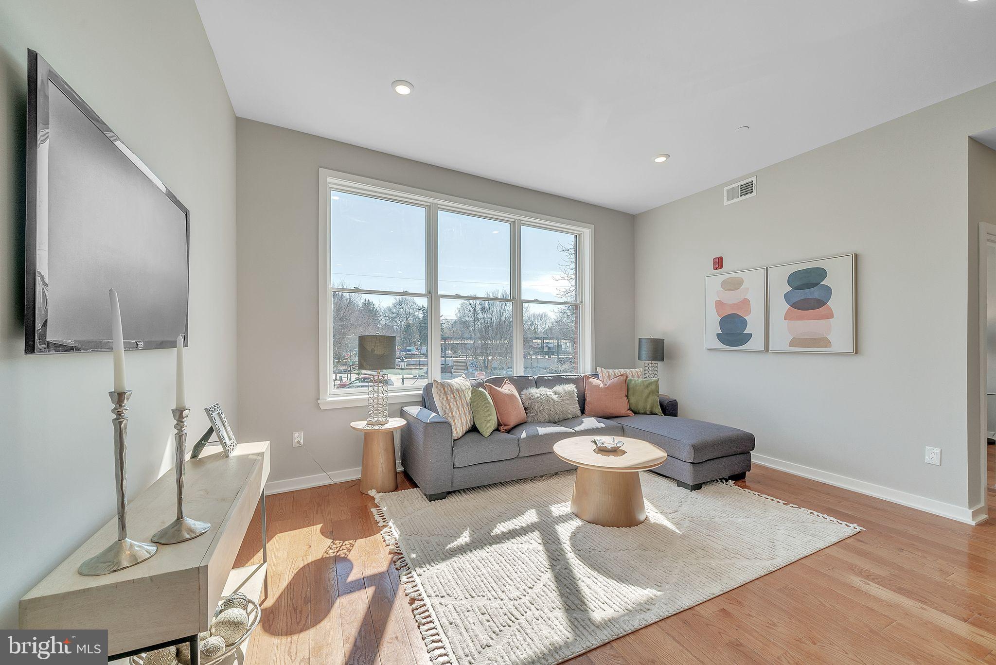 100 Forrest Avenue, Unit 204 Narberth, PA 19072 - Photo 4 of 17 a living room with furniture and a large window