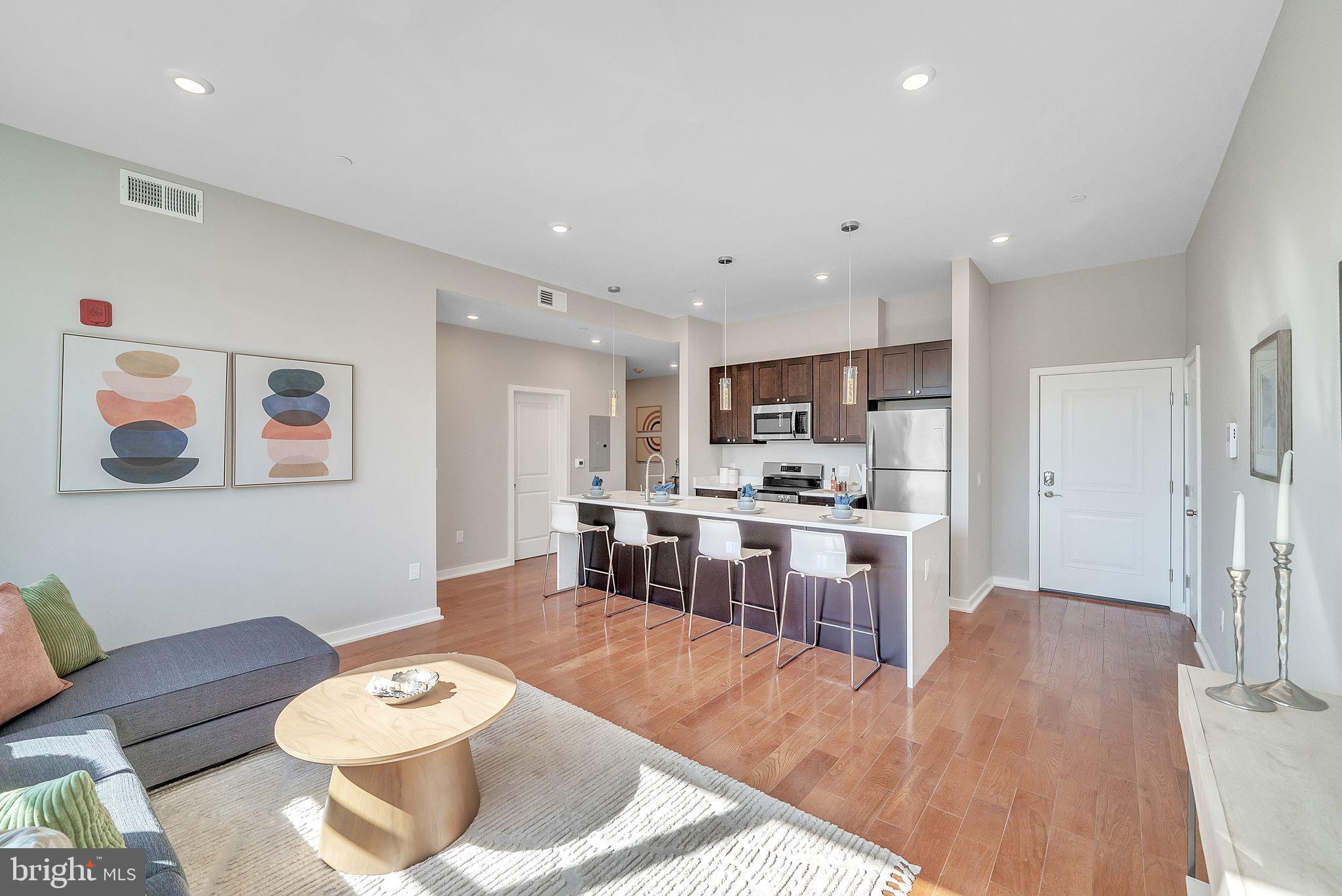 100 Forrest Avenue, Unit 204 Narberth, PA 19072 - Photo 6 of 17 a living room with stainless steel appliances furniture and a kitchen view